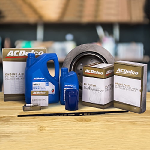 ACDelco auto parts and fluids displayed on wooden surface